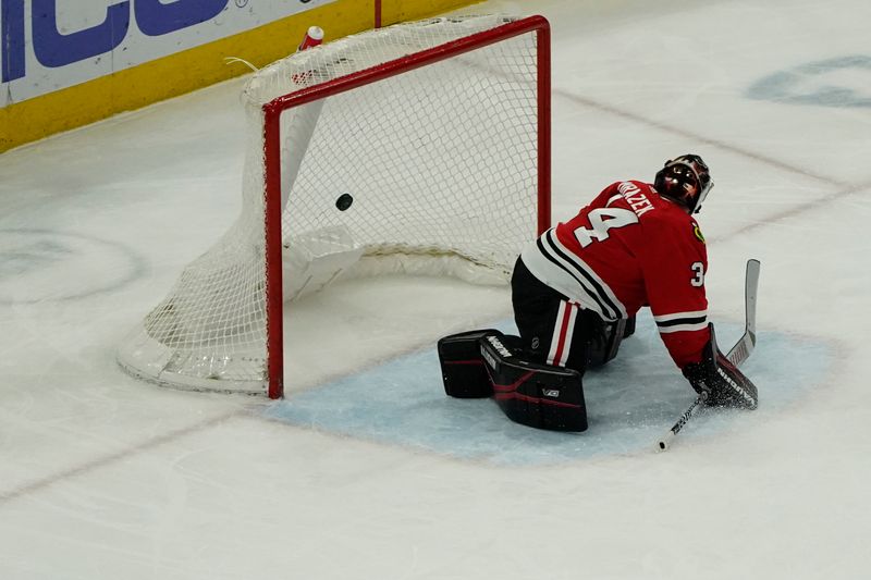 Feb 17, 2024; Chicago, Illinois, USA; Chicago Blackhawks goalie Petr Mrazek (34) watches goal go in by Ottawa Senators defenseman Jakob Chychrun (not pictured) during the second period at United Center. Mandatory Credit: David Banks-USA TODAY Sports