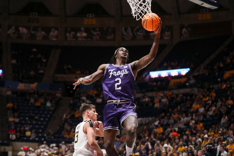 Mar 6, 2024; Morgantown, West Virginia, USA; TCU Horned Frogs forward Emanuel Miller (2) shoots in the lane during the first half against the West Virginia Mountaineers at WVU Coliseum. Mandatory Credit: Ben Queen-USA TODAY Sports