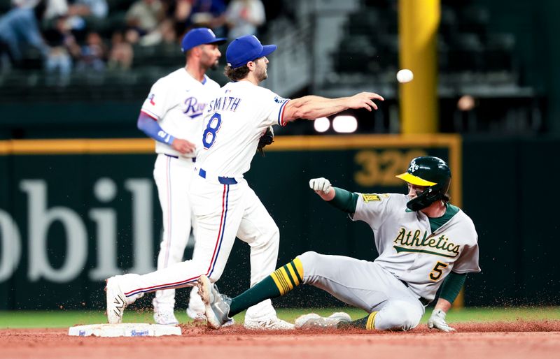 Apr 30, 2025; Arlington, Texas, USA;  Texas Rangers shortstop Josh Smith (8) forces oyt Oakland Athletics shortstop Jacob Wilson (5) and turns a double play during the third inning at Globe Life Field. Mandatory Credit: Kevin Jairaj-Imagn Images