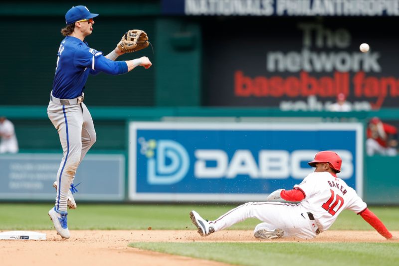 Sep 26, 2024; Washington, District of Columbia, USA; Kansas City Royals shortstop Bobby Witt Jr. (7) attempts to turn a double play at second base ahead of a slide by Washington Nationals second baseman Darren Baker (10) during the eighth inning at Nationals Park. Mandatory Credit: Geoff Burke-Imagn Images