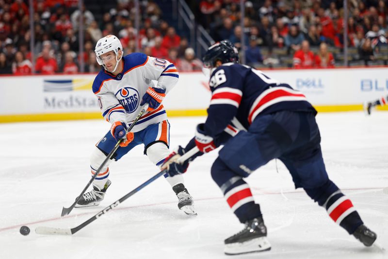 Nov 24, 2023; Washington, District of Columbia, USA; Edmonton Oilers center Derek Ryan (10) and Washington Capitals right wing Nicolas Aube-Kubel (96) battle for the puck in the third period at Capital One Arena. Mandatory Credit: Geoff Burke-USA TODAY Sports