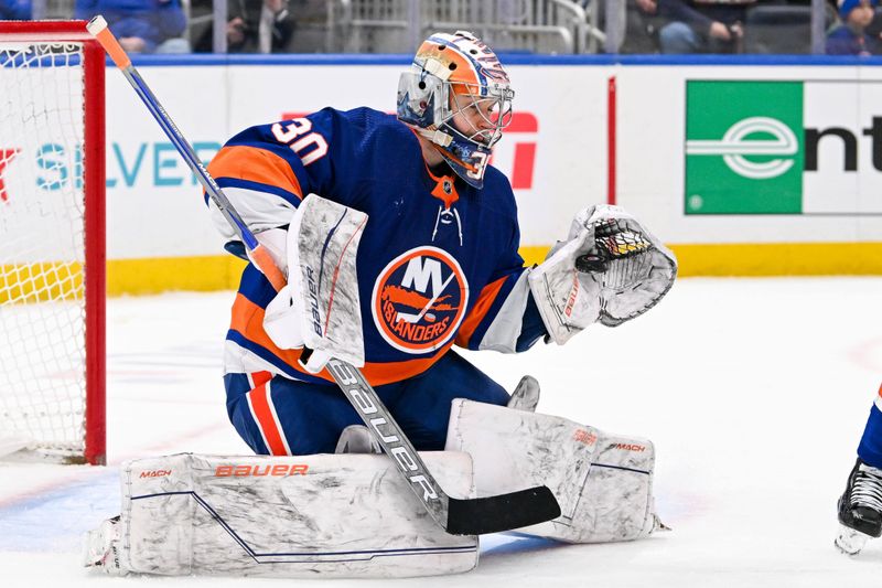 Feb 8, 2024; Elmont, New York, USA; New York Islanders goaltender Ilya Sorokin (30) makes a save against the Tampa Bay Lightning during the third period at UBS Arena. Mandatory Credit: Dennis Schneidler-USA TODAY Sports