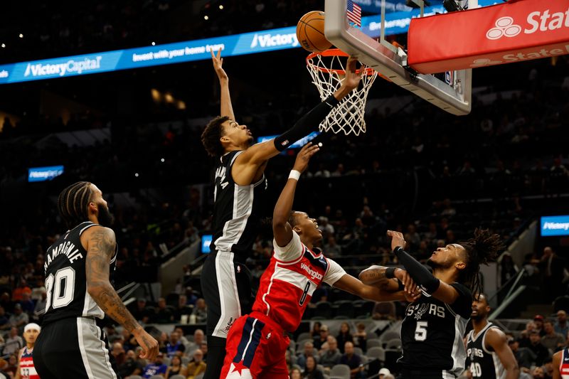 SAN ANTONIO, TX - NOVEMBER 13:  Victor Wembanyama #1 of the San Antonio Spurs blocks a shot of Carlton Carrington #8 of the Washington Wizards in the first half at Frost Bank Center on November 13, 2024 in San Antonio, Texas. NOTE TO USER: User expressly acknowledges and agrees that, by downloading and or using this photograph, User is consenting to terms and conditions of the Getty Images License Agreement. (Photo by Ronald Cortes/Getty Images)