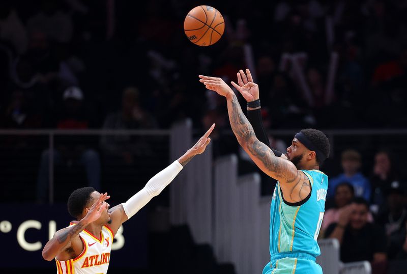 ATLANTA, GEORGIA - MARCH 23:  Miles Bridges #0 of the Charlotte Hornets shoots against Dejounte Murray #5 of the Atlanta Hawks during the first quarter at State Farm Arena on March 23, 2024 in Atlanta, Georgia.  NOTE TO USER: User expressly acknowledges and agrees that, by downloading and/or using this photograph, user is consenting to the terms and conditions of the Getty Images License Agreement.  (Photo by Kevin C. Cox/Getty Images)