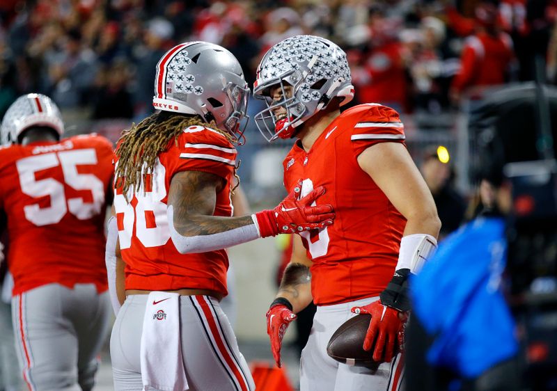 Nov 18, 2023; Columbus, Ohio, USA;  Ohio State Buckeyes tight end Cade Stover (8) celebrates his touchdown catch with tight end Gee Scott Jr. (88) during the third quarter against the Minnesota Golden Gophers at Ohio Stadium. Mandatory Credit: Joseph Maiorana-USA TODAY Sports