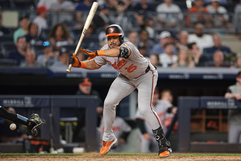 Jun 18, 2024; Bronx, New York, USA; Baltimore Orioles right fielder Anthony Santander (25) avoids being hit by a pitch during the sixth inning against the New York Yankees at Yankee Stadium. Mandatory Credit: Vincent Carchietta-USA TODAY Sports