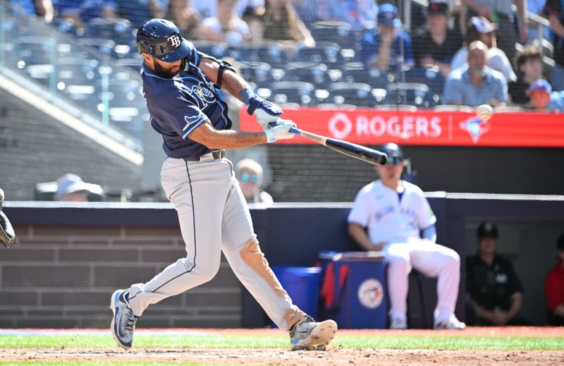 Jul 25, 2024; Toronto, Ontario, CAN; Tampa Bay Rays third baseman Ahmed Rosario (10) hits a single against the Toronto Blue Jays in the sixth inning at Rogers Centre. Mandatory Credit: Dan Hamilton-USA TODAY Sports