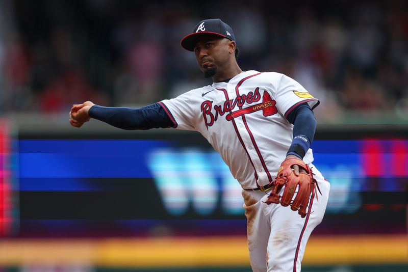 Sep 30, 2024; Atlanta, Georgia, USA; Atlanta Braves second baseman Ozzie Albies (1) throws a runner out at first base against the New York Mets in the fifth inning at Truist Park. Mandatory Credit: Brett Davis-Imagn Images