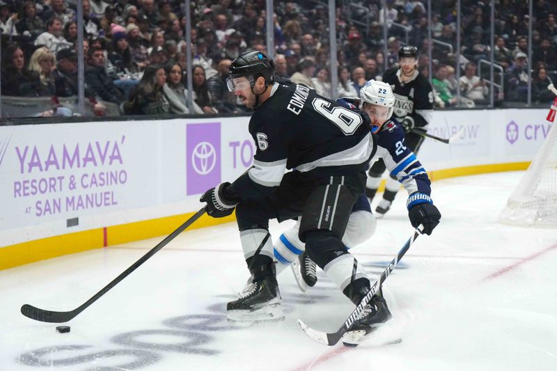 Nov 27, 2024; Los Angeles, California, USA; LA Kings defenseman Joel Edmundson (6) and Winnipeg Jets defenseman Haydn Fleury (24) battle for the puck in the third period at Crypto.com Arena. Mandatory Credit: Kirby Lee-Imagn Images