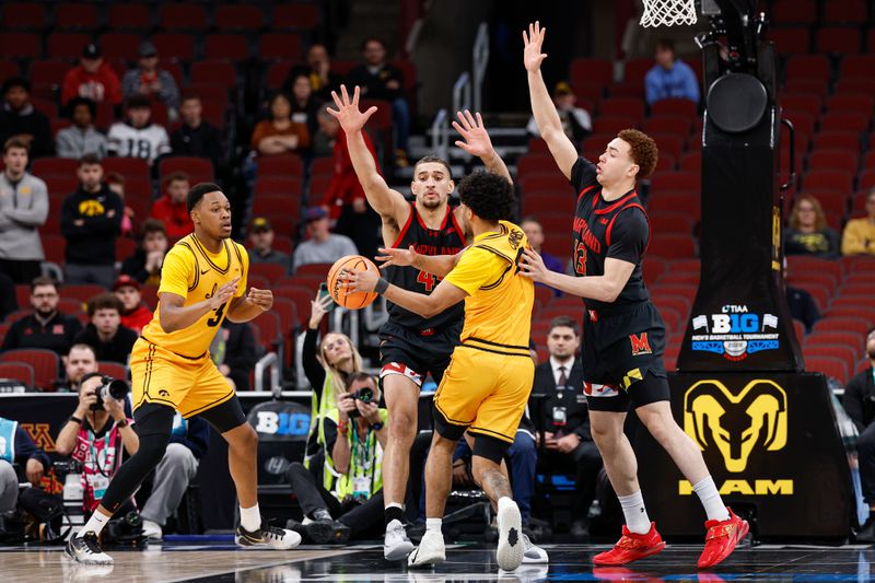 Mar 11, 2026; Chicago, IL, USA; Iowa Hawkeyes guard Kael Combs (11) passes the ball against Maryland Terrapins center Collin Metcalf (45) during the first half at United Center. Mandatory Credit: Kamil Krzaczynski-Imagn Images