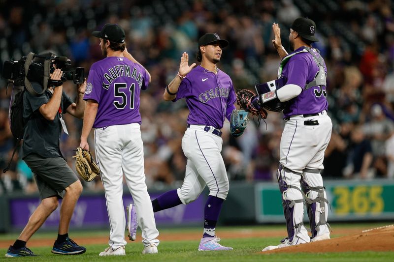 Aug 18, 2023; Denver, Colorado, USA; Colorado Rockies shortstop Ezequiel Tovar (14) celebrates with relief pitcher Karl Kauffmann (51) and catcher Elias Diaz (35) after the game against the Chicago White Sox at Coors Field. Mandatory Credit: Isaiah J. Downing-USA TODAY Sports