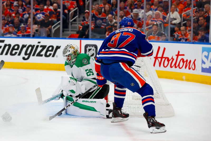 May 27, 2025; Edmonton, Alberta, CAN; Dallas Stars goaltender Jake Oettinger (29) stops a shot by Edmonton Oilers center Connor McDavid (97) during the first period in game four of the Western Conference Final of the 2025 Stanley Cup Playoffs at Rogers Place. Mandatory Credit: Perry Nelson-Imagn Images