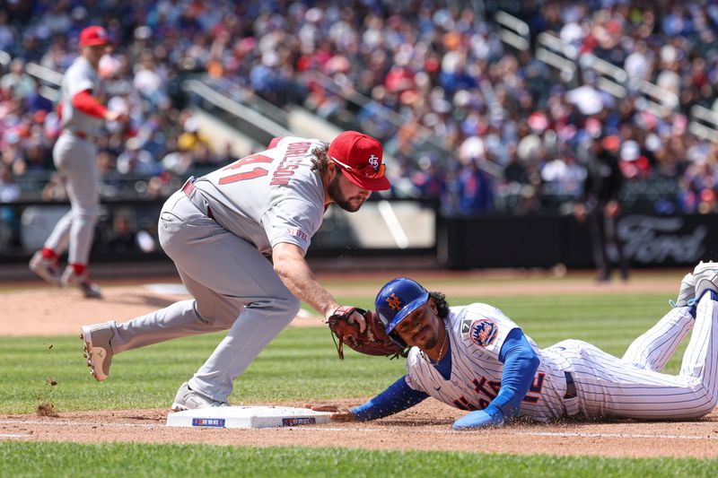 Apr 20, 2025; New York City, New York, USA; New York Mets shortstop Francisco Lindor (12) slides safely back to first base asSt. Louis Cardinals first baseman Alec Burleson (41) tags during the third inning at Citi Field. Mandatory Credit: Vincent Carchietta-Imagn Images