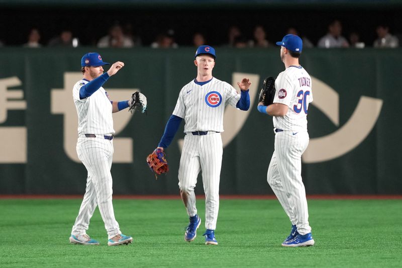 Mar 16, 2025; Bunkyo, Tokyo, Japan; Chicago Cubs center fielder Pete Crow-Armstrong (center) celebrates with right fielder Kyle Tucker (30) and left fielder Ian Happ (left) after defeating the Yomiuri Giants at Tokyo Dome. Mandatory Credit: Darren Yamashita-Imagn Images