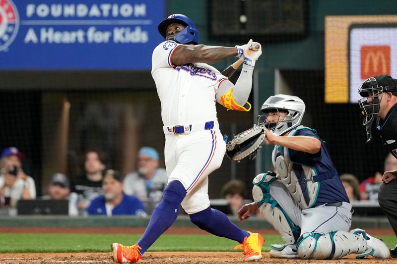 Apr 24, 2024; Arlington, Texas, USA; Texas Rangers right fielder Adolis García (53) hits a home run against the Seattle Mariners during the fourth inning at Globe Life Field. Mandatory Credit: Jim Cowsert-USA TODAY Sports