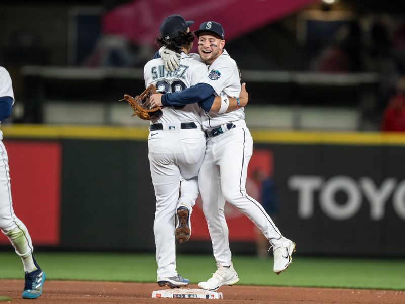 Apr 22, 2023; Seattle, Washington, USA; Seattle Mariners third baseman Eugenio Suarez (28) and left fielder Jarred Kelenic (10) celebrate after a game against the St. Louis Cardinals at T-Mobile Park. Mandatory Credit: Stephen Brashear-USA TODAY Sports