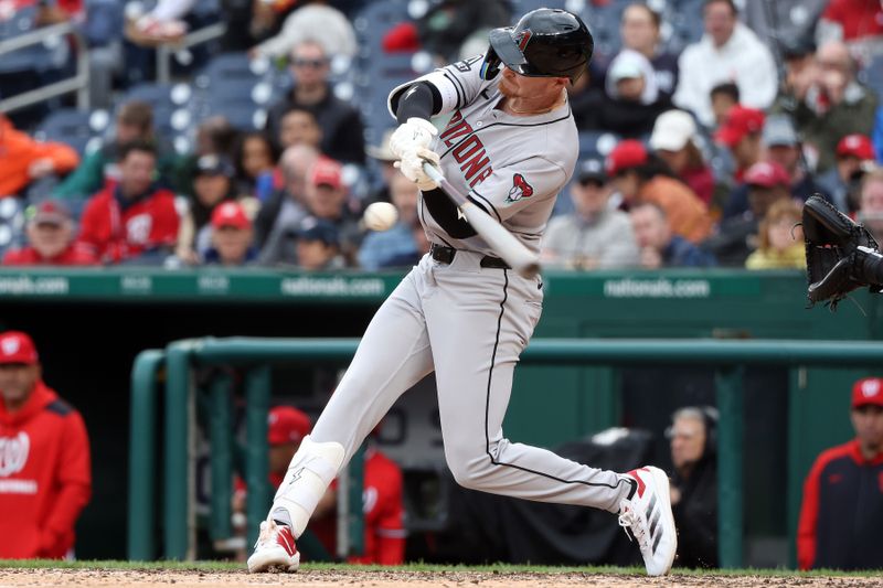 Apr 6, 2025; Washington, District of Columbia, USA; Arizona Diamondbacks outfielder Pavin Smith (26) hits a single during the fifth inning against the Washington Nationals at Nationals Park. Mandatory Credit: Daniel Kucin Jr.-Imagn Images