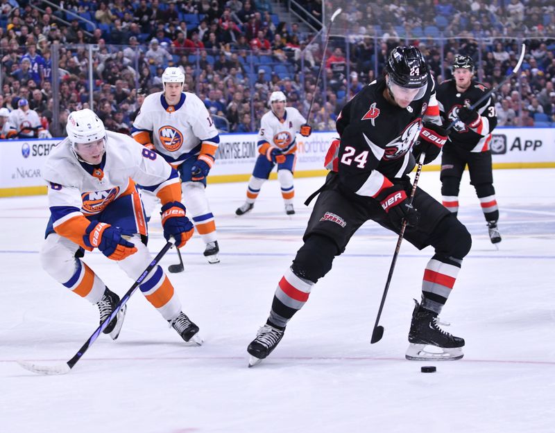 Oct 21, 2023; Buffalo, New York, USA; Buffalo Sabres center Dylan Cozens (24) controls the puck as New York Islanders defenseman Noah Dobson (8) defends in the second period  at KeyBank Center. Mandatory Credit: Mark Konezny-USA TODAY Sports