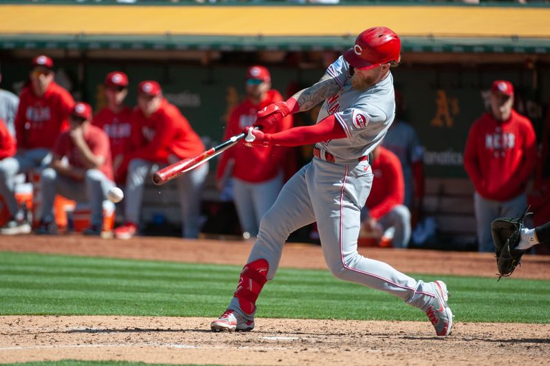 Apr 29, 2023; Oakland, California, USA; Cincinnati Reds right fielder Jake Fraley (27) breaks his bat on an RBI double during the ninth inning against the Oakland Athletics at RingCentral Coliseum. Mandatory Credit: Ed Szczepanski-USA TODAY Sports