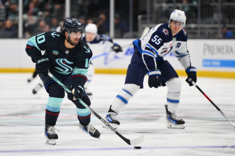 Mar 8, 2024; Seattle, Washington, USA; Seattle Kraken center Matty Beniers (10) advances the puck against the Winnipeg Jets during the second period at Climate Pledge Arena. Mandatory Credit: Steven Bisig-USA TODAY Sports