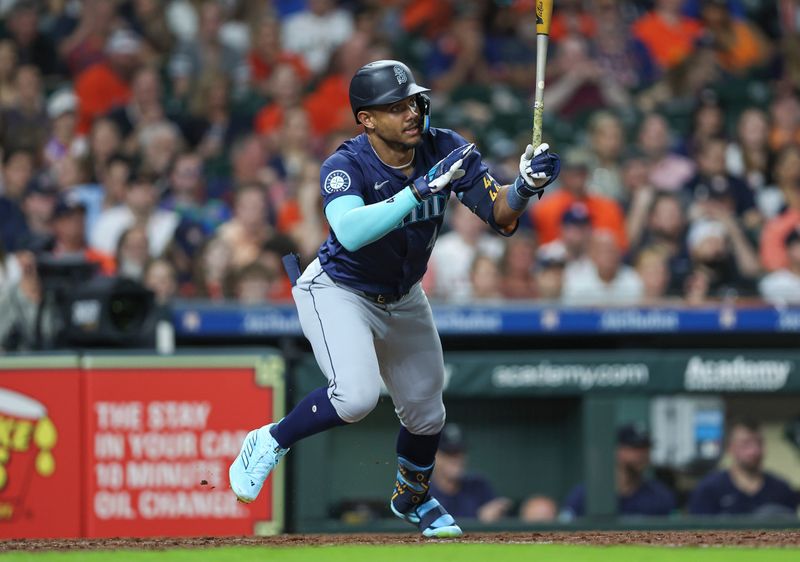 May 3, 2024; Houston, Texas, USA; Seattle Mariners center fielder Julio Rodriguez (44) hits a single during the eighth inning against the Houston Astros at Minute Maid Park. Mandatory Credit: Troy Taormina-USA TODAY Sports