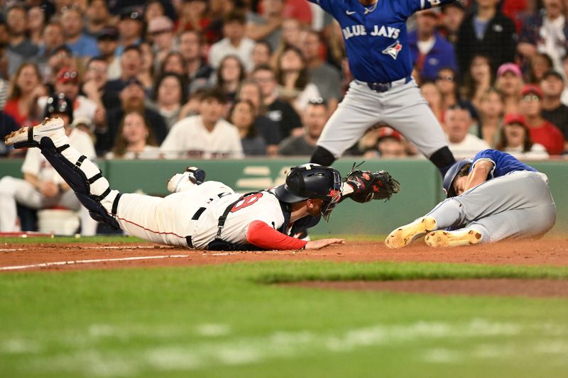 Aug 27, 2024; Boston, Massachusetts, USA; Boston Red Sox catcher Danny Jansen (28) tags out Toronto Blue Jays left fielder Joey Loperfido (9) at home during the second inning at Fenway Park. Mandatory Credit: Brian Fluharty-USA TODAY Sports