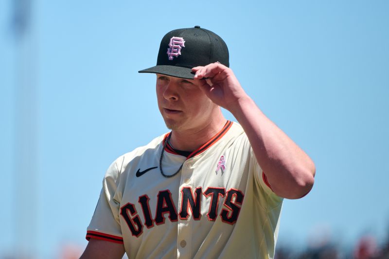 May 12, 2024; San Francisco, California, USA; San Francisco Giants starting pitcher Kyle Harrison (45) walks to the dugout after the last out of the third inning against the Cincinnati Reds at Oracle Park. Mandatory Credit: Robert Edwards-USA TODAY Sports