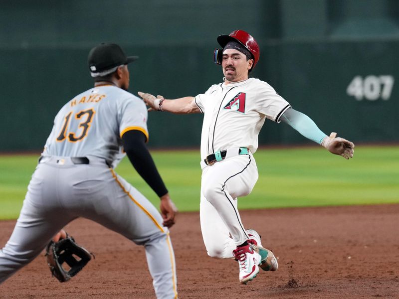 Jul 26, 2024; Phoenix, Arizona, USA; Arizona Diamondbacks outfielder Corbin Carroll (7) slides into third base ahead of a throw to Pittsburgh Pirates third base Ke'Bryan Hayes (13) for a triple during the third inning at Chase Field. Mandatory Credit: Joe Camporeale-USA TODAY Sports