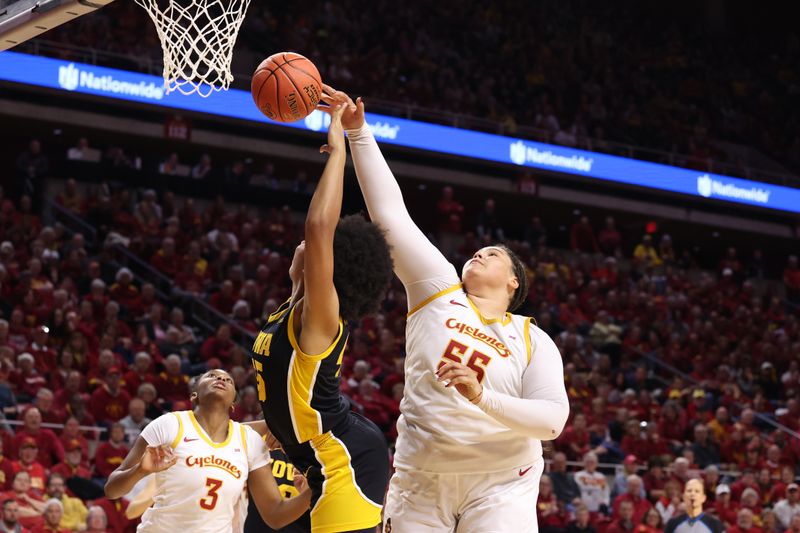 Dec 10, 2025; Ames, Iowa, USA; Iowa State Cyclones Audi Crooks (55) blocks the shot of Iowa Hawkeyes Hannah Stuelke (45) during the second half at James H. Hilton Coliseum. Mandatory Credit: Reese Strickland-Imagn Images