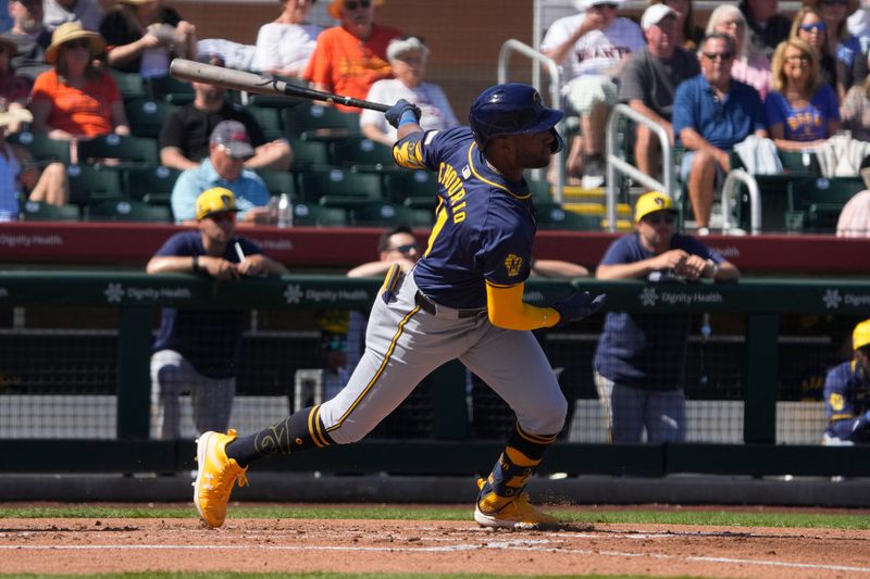 Mar 5, 2024; Scottsdale, Arizona, USA; Milwaukee Brewers centerfielder Jackson Chourio (11) hits an RBI double against the San Francisco Giants in the first inning at Scottsdale Stadium. Mandatory Credit: Rick Scuteri-USA TODAY Sports