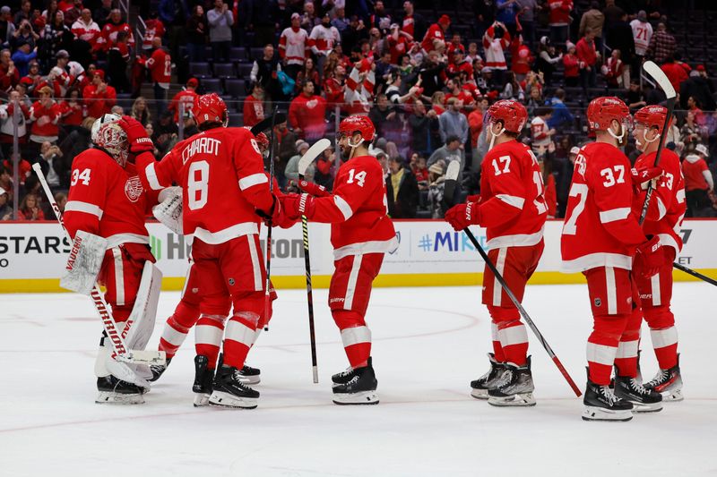 Jan 13, 2024; Detroit, Michigan, USA;  Detroit Red Wings goaltender Alex Lyon (34) receives congratulations from teammates after defeating the Los Angeles Kings at Little Caesars Arena. Mandatory Credit: Rick Osentoski-USA TODAY Sports