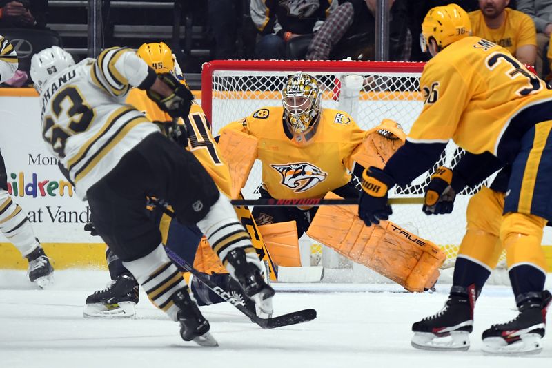 Apr 2, 2024; Nashville, Tennessee, USA; Nashville Predators goaltender Juuse Saros (74) makes a save on a shot by Boston Bruins left wing Brad Marchand (63) during the first period at Bridgestone Arena. Mandatory Credit: Christopher Hanewinckel-USA TODAY Sports