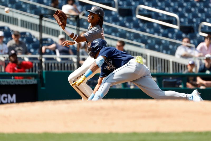 Apr 5, 2023; Washington, District of Columbia, USA; Tampa Bay Rays center fielder Jose Siri (22) is tagged out at third base on a throw to Washington Nationals shortstop CJ Abrams (5) during the sixth inning at Nationals Park. Mandatory Credit: Geoff Burke-USA TODAY Sports