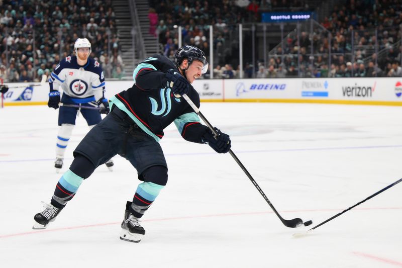 Mar 8, 2024; Seattle, Washington, USA; Seattle Kraken center Yanni Gourde (37) shoots the puck against the Winnipeg Jets during the second period at Climate Pledge Arena. Mandatory Credit: Steven Bisig-USA TODAY Sports