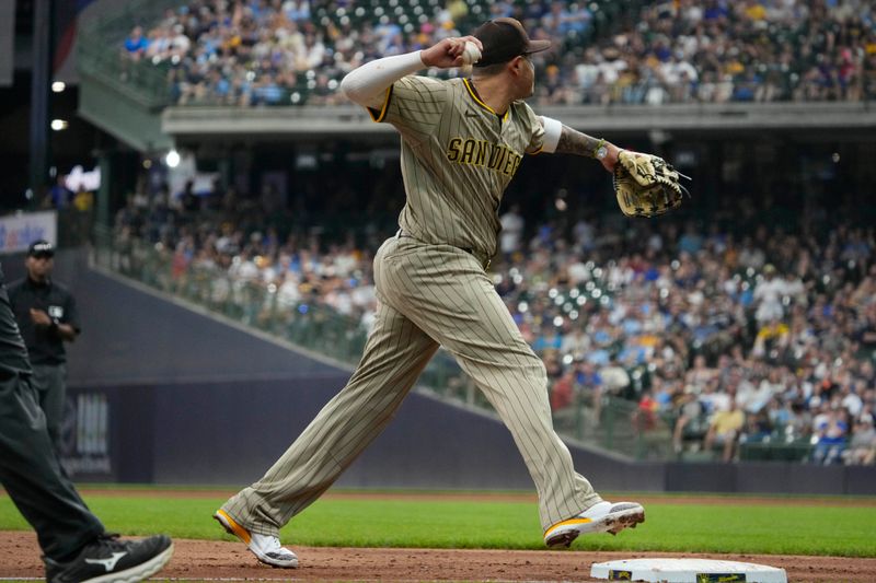 Jun 8, 2025; Milwaukee, Wisconsin, USA; San Diego Padres third base Manny Machado (13) fields the ball and gets the force out at third base against the Milwaukee Brewers in the seventh inning at American Family Field. Mandatory Credit: Michael McLoone-Imagn Images