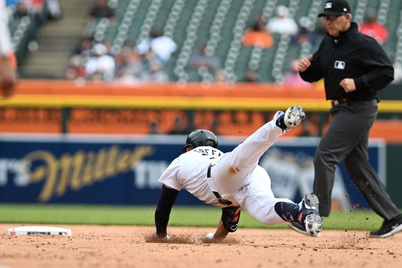 Apr 18, 2024; Detroit, Michigan, USA;  Detroit Tigers left fielder Riley Greene (31) slides head first into second base for a double against the Texas Rangers in the fourth inning at Comerica Park. Mandatory Credit: Lon Horwedel-USA TODAY Sports