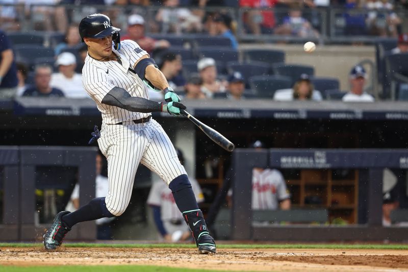 Jun 22, 2024; Bronx, New York, USA;  New York Yankees designated hitter Giancarlo Stanton (27) hits a double against the Atlanta Braves in the fourth inning at Yankee Stadium. Mandatory Credit: Wendell Cruz-USA TODAY Sports