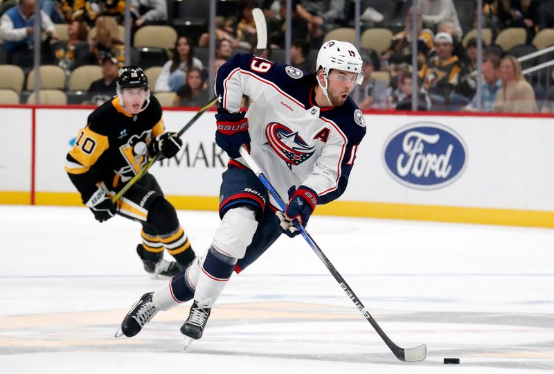 Oct 4, 2024; Pittsburgh, Pennsylvania, USA;  Columbus Blue Jackets center Adam Fantilli (19) breaks up ice with the puck against the Pittsburgh Penguins during the second period at PPG Paints Arena. Mandatory Credit: Charles LeClaire-Imagn Images