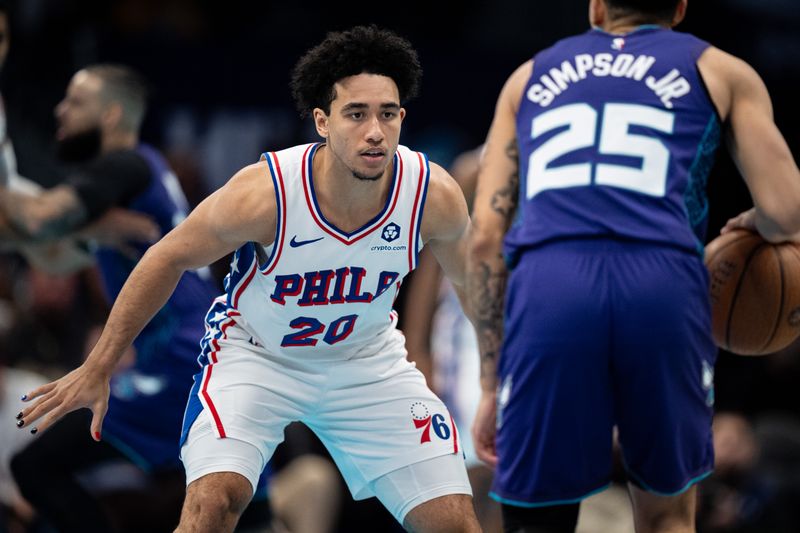 CHARLOTTE, NORTH CAROLINA - DECEMBER 03: Jared McCain #20 of the Philadelphia 76ers guards KJ Simpson #25 of the Charlotte Hornets in the third quarter of the game during the Emirates NBA Cup at Spectrum Center on December 03, 2024 in Charlotte, North Carolina. NOTE TO USER: User expressly acknowledges and agrees that, by downloading and or using this photograph, User is consenting to the terms and conditions of the Getty Images License Agreement. (Photo by Jacob Kupferman/Getty Images)