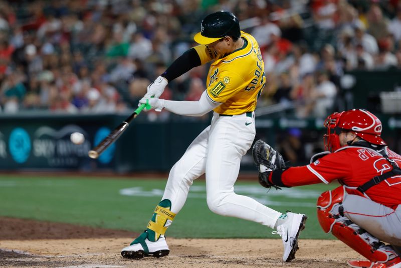 May 20, 2025; West Sacramento, California, USA; Athletics left fielder Tyler Soderstrom (21) hits a double during the seventh inning against the Los Angeles Angels at Sutter Health Park. Mandatory Credit: Sergio Estrada-Imagn Images