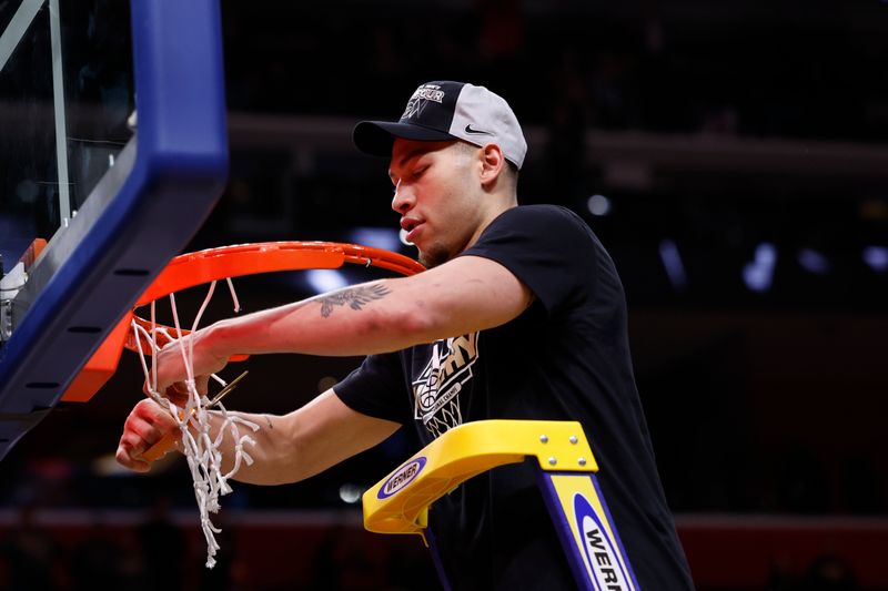 Mar 31, 2024; Detroit, MI, USA; Purdue Boilermakers forward Mason Gillis (0) cuts down the net after defeating the Tennessee Volunteers during the NCAA Tournament Midwest Regional Championship at Little Caesars Arena. Mandatory Credit: Rick Osentoski-USA TODAY Sports
