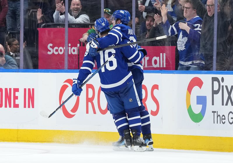 Mar 6, 2024; Toronto, Ontario, CAN; Toronto Maple Leafs center Auston Matthews (34) scores the winning goal and celebrates with Toronto Maple Leafs right wing Mitchell Marner (16) against the Buffalo Sabres during the overtime period at Scotiabank Arena. Mandatory Credit: Nick Turchiaro-USA TODAY Sports