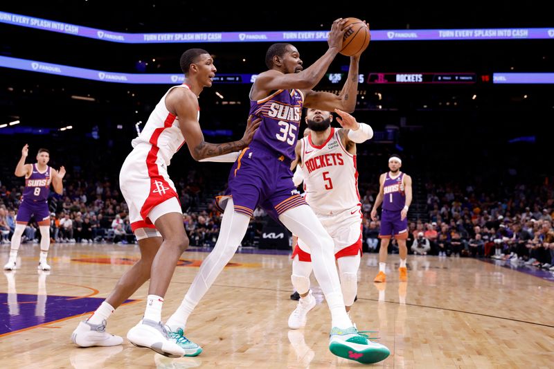 PHOENIX, ARIZONA - MARCH 02: Kevin Durant #35 of the Phoenix Suns is pressured by Fred VanVleet #5 and Jabari Smith Jr. #10 of the Houston Rockets during the first half at Footprint Center on March 02, 2024 in Phoenix, Arizona. NOTE TO USER: User expressly acknowledges and agrees that, by downloading and or using this photograph, User is consenting to the terms and conditions of the Getty Images License Agreement.  (Photo by Chris Coduto/Getty Images)