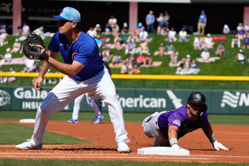 Feb 29, 2024; Mesa, Arizona, USA; Colorado Rockies shortstop Ezequiel Tovar (14) dives back into firstbase safely against the Chicago Cubs first baseman Patrick Wisdom (16) in the first inning at Sloan Park. Mandatory Credit: Rick Scuteri-USA TODAY Sports