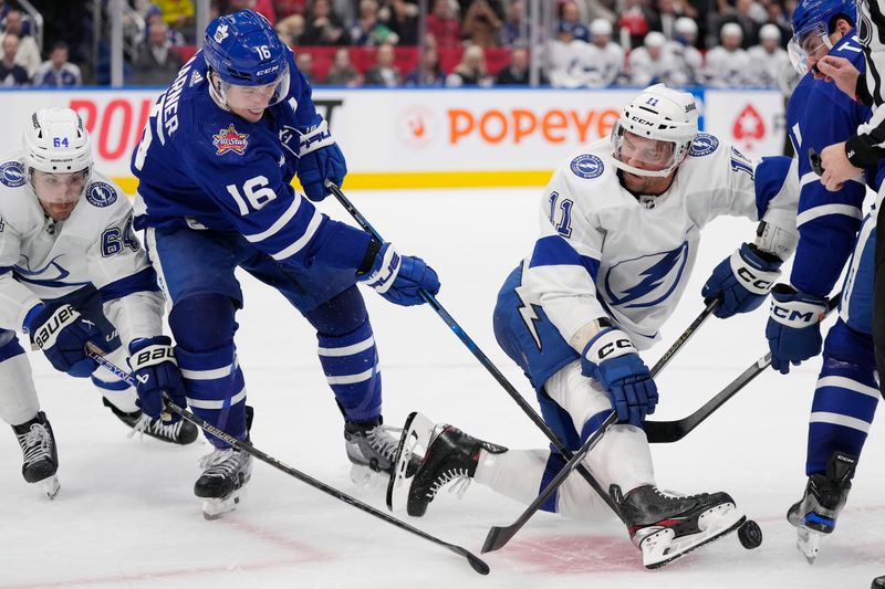 Nov 6, 2023; Toronto, Ontario, CAN; Toronto Maple Leafs forward Mitchell Marner (16) battles with Tampa Bay Lightning forward Tyler Motte (64) and forward Luke Glendening (11) for the puck during the third period at Scotiabank Arena. Mandatory Credit: John E. Sokolowski-USA TODAY Sports