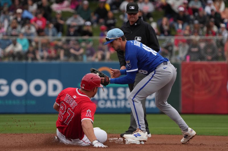 Mar 14, 2025; Tempe, Arizona, USA; Los Angeles Angels outfielder Mike Trout (27) slides into second base under the tag of Kansas City Royals iCavan Biggio n the first inning at Tempe Diablo Stadium. Mandatory Credit: Rick Scuteri-Imagn Images