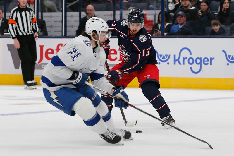 Feb 10, 2024; Columbus, Ohio, USA; Columbus Blue Jackets left wing Johnny Gaudreau (13) carries the puck past the check of Tampa Bay Lightning center Anthony Cirelli (71) during the second period at Nationwide Arena. Mandatory Credit: Russell LaBounty-USA TODAY Sports