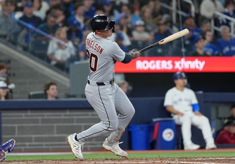 May 18, 2025; Toronto, Ontario, CAN; Detroit Tigers first baseman Spencer Torkelson (20) hits an RBI single against the Toronto Blue Jays during the seventh inning at Rogers Centre. Mandatory Credit: Nick Turchiaro-Imagn Images