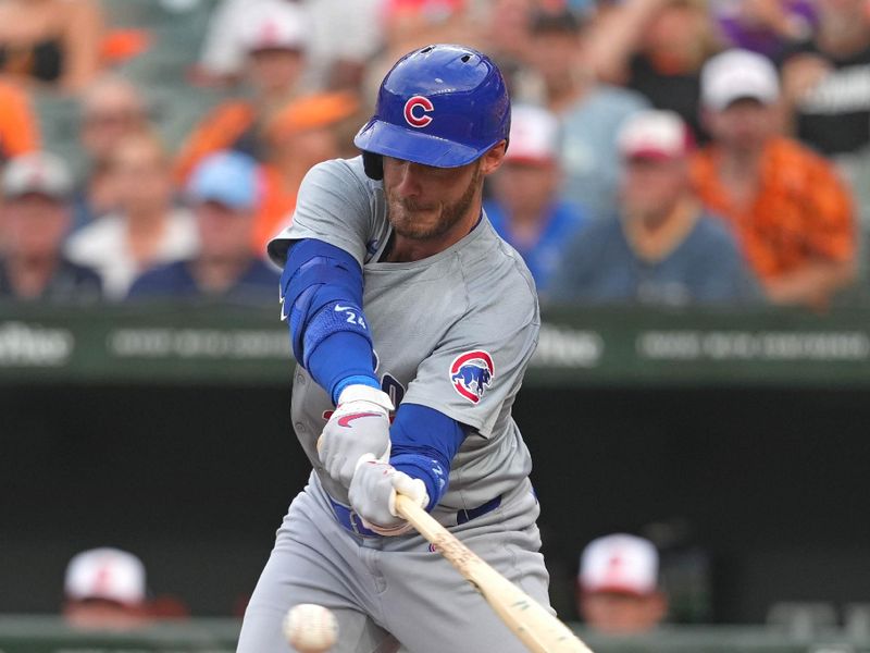 Jul 9, 2024; Baltimore, Maryland, USA; Chicago Cubs outfielder Cody Bellinger (24) connects on a third inning single against the Baltimore Orioles at Oriole Park at Camden Yards. Mandatory Credit: Mitch Stringer-USA TODAY Sports