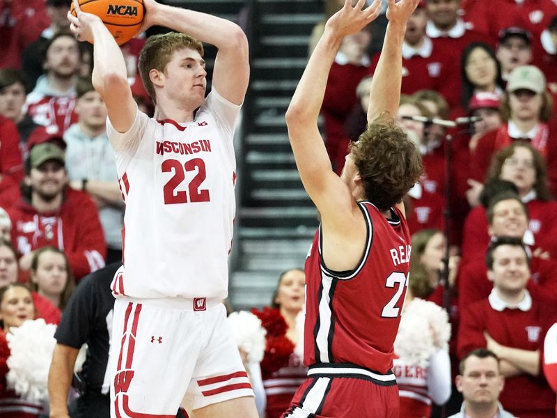 Feb 18, 2023; Madison, Wisconsin, USA;  Wisconsin Badgers forward Steven Crowl (22) passes against Rutgers Scarlet Knights forward Dean Reiber (21) during the first half at the Kohl Center. Mandatory Credit: Kayla Wolf-USA TODAY Sports